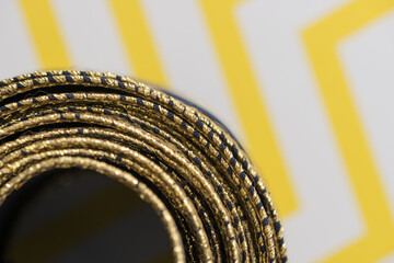 intricate but visually attractive navy blue and gold ribbon close up