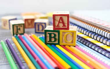 Wooden alphabet blocks on a white wooden background. Back to school, games for kindergarten,...