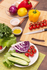 Different vegetables for cooking healthy vegetarian vegan diet food. Cutting vegetable for salad on wooden board on kitchen