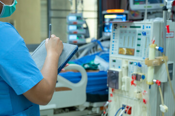 Nurses are checking the function of the hemodialysis machine before use in patients with chronic renal failure.