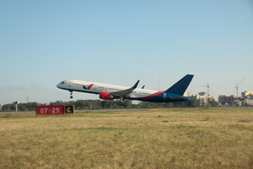 Fototapeta na wymiar Passenger plane takes off from the airport runway