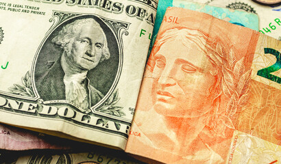 Dinheiro, Real e Dólar americano. Cédula do Real Brasileiro sobre Dólares dos Estados Unidos. Conceito de mercado de câmbio e investimentos internacionais.