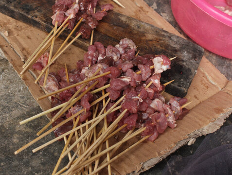 Raw chicken satay ready to be grilled. The process of burning savory beef satay with spicy spices over hot coals.hot and spacy satay