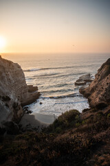 A secret beach protected by cliffs on a beautiful sunset
