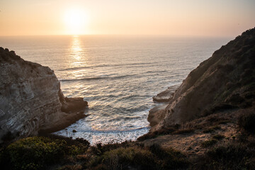 The sea between big cliffs on a beautiful sunset