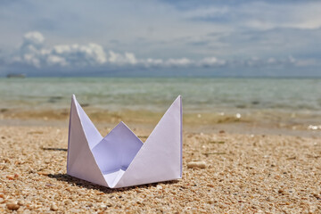 paper boat on the beach