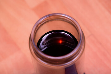 Take a close-up shot of a glass of tea from above