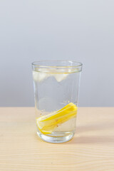 A glass of lemon infused water.