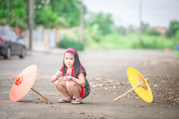close-up background view of an asian girl Running around and carrying parasols during school...