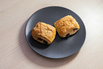 Two mini croissants on a plate.