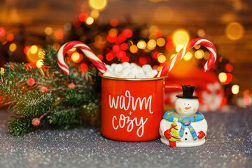 Festive mood. Hot chocolate with marshmallows. Christmas hot drinks. Hot winter drink. Chocolate with whipped cream in red mug. Christmas time. Cozy home atmosphere. Mug with cocoa. Christmas ornament