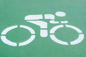 Bicycle symbol paint white color on green road for biking track safety
