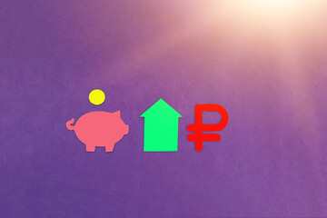 Piggy bank, a coin, a green house, a ruble sign on a purple background. The concept of financial investments. housing business.