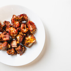 Top view of pork ribs fried with garlic and pepper. white background