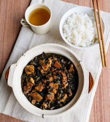 Delicious homemade meal. Stew Mui Choy aka Preserved Vegetable with Pork Belly. A popular dish made famous by the Hakka people, the pork belly;s fat melts in your mouth, eaten with rice or porridge.
