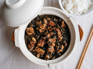 Delicious homemade meal. Stew Mui Choy aka Preserved Vegetable with Pork Belly. A popular dish made famous by the Hakka people, the pork belly;s fat melts in your mouth, eaten with rice or porridge.