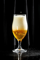 Frosty glass of light beer, craft beer with thick foam, vertical image. place for text