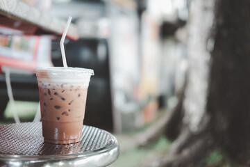 Iced Mocha coffee in transparent plastic glass on the table.