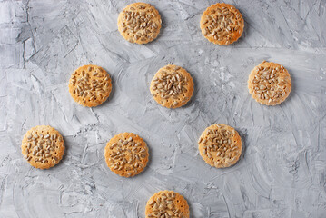 Healthy oatmeal cookies on plate over gray stone background, top view