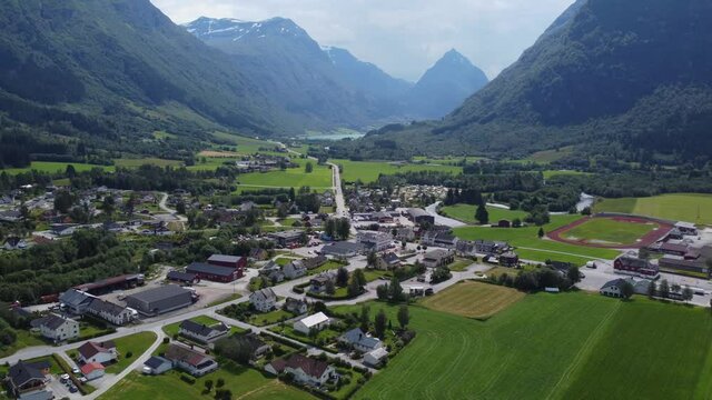 General sunny day overview of Byrkjelo town-center with road E39 passing through - Cozy Norway village during summer day