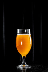 Glass of light beer on dark background. craft beer, vertical image. place for text