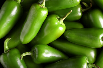 Green jalapeno peppers as background, closeup