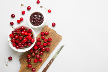 Composition with ripe cherry and jam on white background