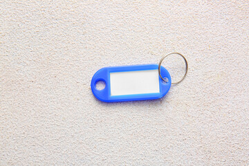 Plastic key tag on light background