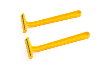 twin blades yellow disposable shaving razors isolated on a white background.