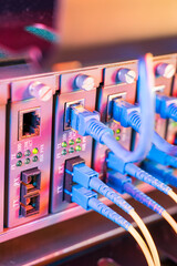 Fiber Optical cables connected to an optic ports and Network cables connected to ethernet ports