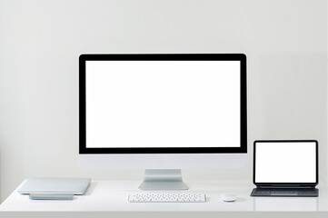 Mockup blank screen desktop computer and tablet on white wooden table.