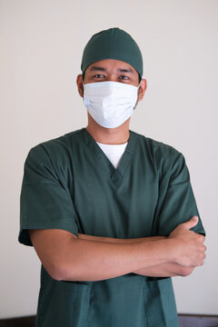 Asian Nurse Man Standing With Hands Folded Across Chest