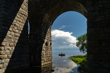 Fishing boat on Lake Baikal near the old bridge