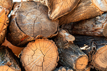 Natural wooden background - closeup of chopped firewood.   Logs cut stacked