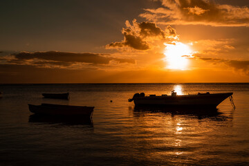 Fishing boat on the beach of Albion at sunset in the west of the republic of Mauritius, East Africa