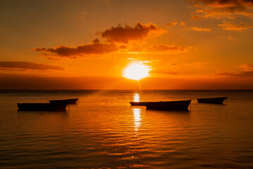 Fototapeta na wymiar Fishing boat on the beach of Albion at sunset in the west of the republic of Mauritius, East Africa