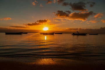 Fishing boat on the beach of Albion at sunset in the west of the republic of Mauritius, East Africa