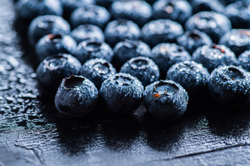 Freshly harvested blueberries with water drops. Selective focus.
