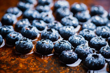 Freshly harvested blueberries with water drops. Selective focus.
