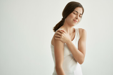 Fototapeta premium woman with joint pain health problems dissatisfaction light background
