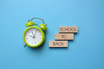 school background with an alarm clock and the inscription: "Back to school!"