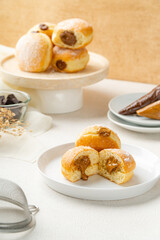 A bombolone or bomboloni is an Italian filled doughnut and is eaten as a snack food and dessert. This Bomboloni has many flavors like strawberry, chocolate, blueberry, etc.