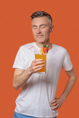 Man with closed eyes with glass of fruit cocktail