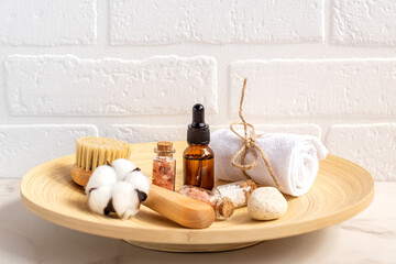 Close-up of bathroom beauty set in wooden basket on white background. Persona accessories on a...