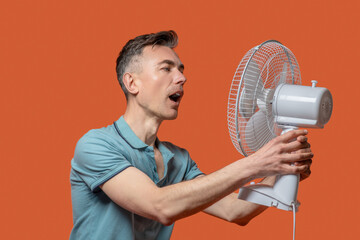 Man with open mouth in front of ventilator
