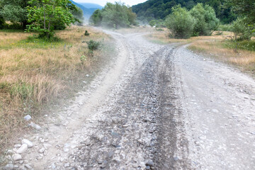 Fototapeta na wymiar Dirt road in a mountainous area