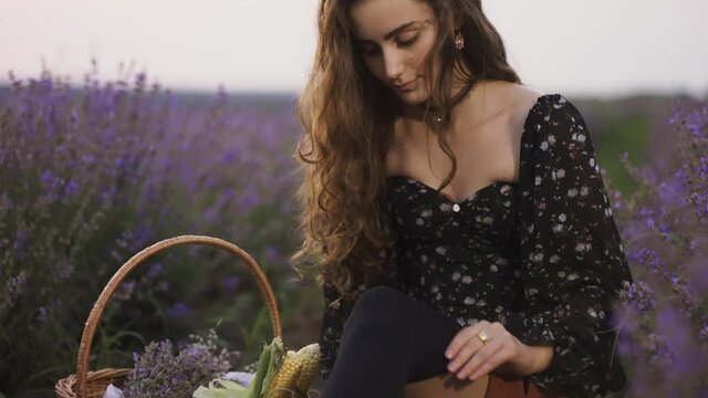 Sensual woman on lavender field, putting on black tights