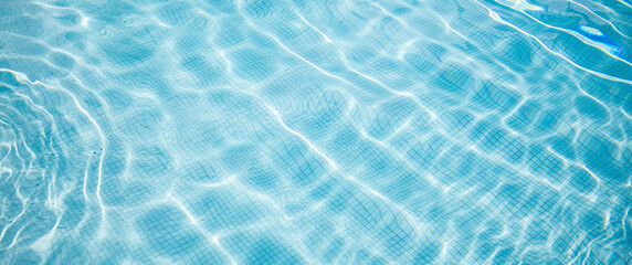 Surface of blue swimming pool. Summer water sport, recreational background. Texture of water surface, blue turquoise vivid bright sunny day closeup.