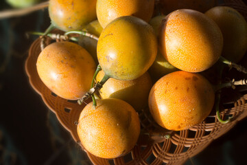 Yellow passion Marquisa fruits. The Bali fruits, Indonesia. Asia fruit in a bowl on the table background.