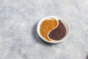 Organic mustard seeds in a small bowl.